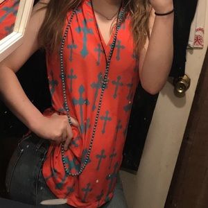 orange cross , no sleeve shirt